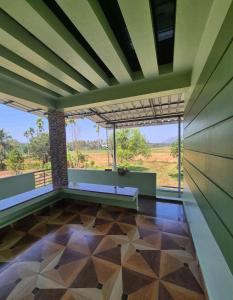 an empty room with a view of a field at meadowell homestay in Kizhake Chālakudi