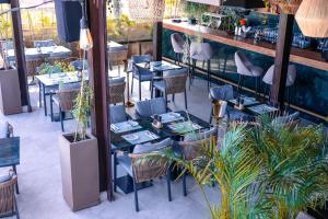 a restaurant with blue tables and chairs and plants at Longue vie Hotels in Marrakesh