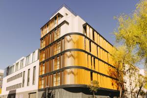 an office building with a yellow facade at Hotel Pax Atocha in Madrid