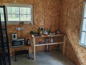 a small kitchen with a table and a microwave at Nature Reserve Hideaway in Nohipalu +20 photos