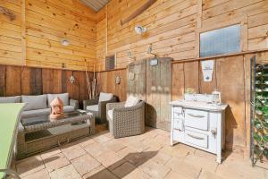 a living room with wooden walls and a patio at Chambres D'hôtes La Boriette in Castelnau-de-Montmiral