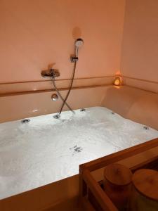 a bath tub with a light on the side of it at Eftychia's House in Lofou +41 photos