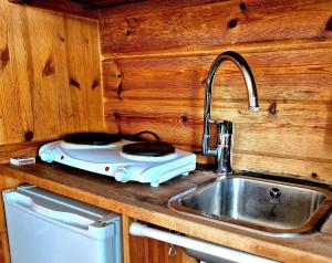 a kitchen with a stove and a sink and a counter at Aurora Camp Kiruna in Kiruna +160 photos