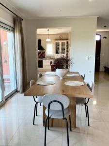 a dining room table and chairs in a kitchen at Horizon House, with Olive Grove and a small Vineyard in Amarynthos