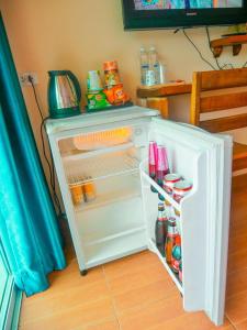an open refrigerator with food inside of it at Ingtarn Ressort At thasala อิงธารรีสอร์ท ท่าศาลา in Ban Nai Thung
