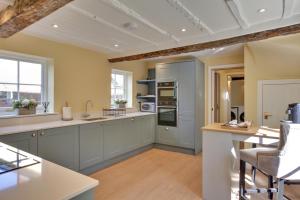 a kitchen with gray cabinets and a counter top at Finest Retreats - Josua, Maldon in Maldon