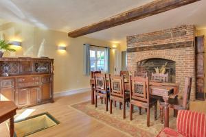 a living room with a brick fireplace and a table and chairs at Finest Retreats - Josua, Maldon in Maldon +34 photos