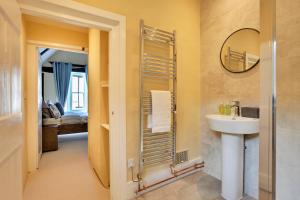 a bathroom with a sink and a mirror at Finest Retreats - Josua, Maldon in Maldon