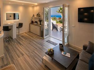 a living room with a view of the ocean at Barracuda Suite Sea View & Dinner Experience in Ischia Town
