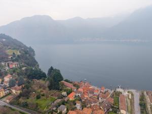 a town on a hill next to a body of water at Historic Borgo Lake Como Campidoglio 3 in Lenno