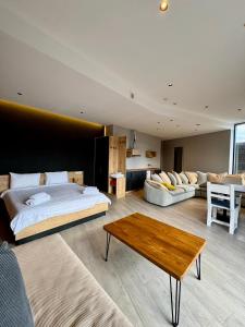 a bedroom with a bed and a couch and a table at Chiko Group in Aspindza