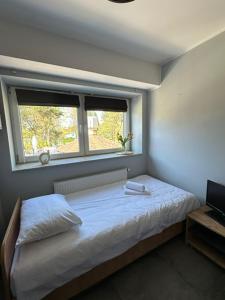 a small bedroom with a bed and a window at Jurajska Przystań in Jastrząb +59 photos