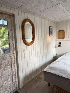 a bedroom with a bed and a mirror on the wall at Bolding Apartments in Billund