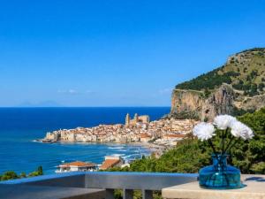 a blue vase with white flowers on a ledge at Infinity Blue in Cefalù