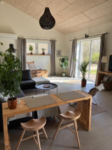 a living room with a wooden table and chairs at Bolding Apartments in Billund