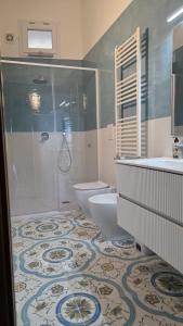a bathroom with a shower and a toilet and a sink at Seaview Home Bacoli in Bacoli +12 photos