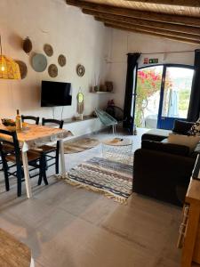 a living room with a table and a couch at Casa Caleca guest house with private pool in Tavira