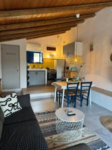a living room with a table and a kitchen at Casa Caleca guest house with private pool in Tavira