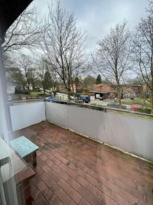 a balcony with a bench and a white fence at GM Zimmervermietung in Hamburg +10 photos