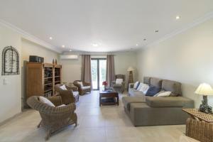 a living room with a couch and chairs at Villa Isabelle by Algarve Holidays - Loule in Loulé