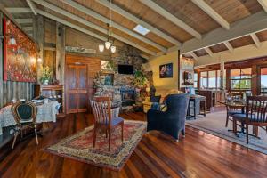 a living room with wooden floors and a living room with a fireplace at Tamborine Mountain Bed and Breakfast in Mount Tamborine