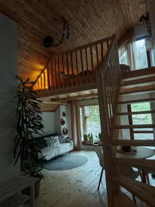 a living room with a staircase in a house at Casa Lucia in Dămuc