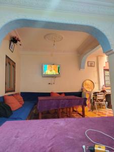 a living room with a couch and a table at kasbah Riad dar Ahlam in Aït Baha
