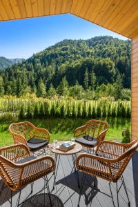 a group of chairs and a table on a patio at NATURAMA Glockenalm in Fischbachau