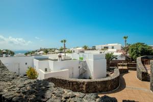 a view of a villa with white buildings at Apartamentos LIVVO Coloradamar in Playa Blanca