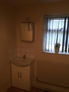 a bathroom with a sink and a window at 24/7 London Hostel in London +51 photos