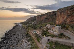 an aerial view of a building on the side of a mountain at Alkyon SeaSide Studios in Neo Itilo