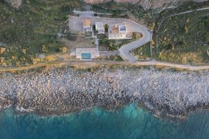 an aerial view of a house next to the ocean at Alkyon SeaSide Studios in Neo Itilo +52 photos