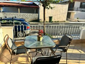a table and chairs on a patio with a car at Sweet Studio in Leptokarya +8 photos