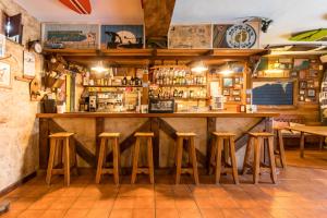 a bar in a restaurant with stools at the counter at Casa Del Surf Somo in Somo