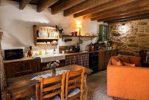 a kitchen with a table and a sink and a counter at Casa do Tio Zé Montesinho in Montezinho