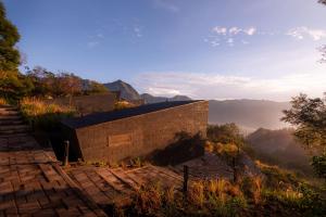 a building on a hill with a view of the mountains at ARTOTEL Cabin Bromo in Bromo
