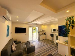 a living room with a couch and a table at Barracuda Suite Sea View & Dinner Experience in Ischia Town