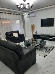 a living room with a couch and a table at Casuarina Apartments in Livingstone