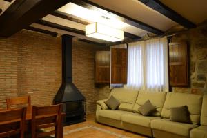 a living room with a couch and a stove at Casa Domingo in Manzanera