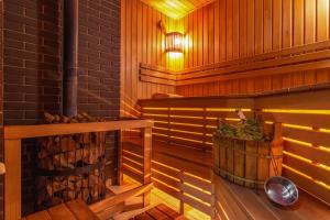 a sauna with a wood stove and a wooden floor at Hotel AnOrita in Kobuleti