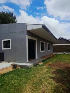 a small house with a yard in front of it at Larami House Narok in Narok