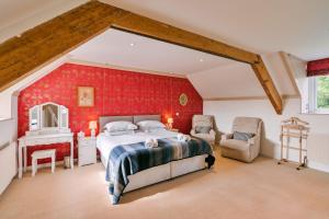 a bedroom with a bed and a red wall at Finest Retreats - Wallingbrook Lodge in Chulmleigh