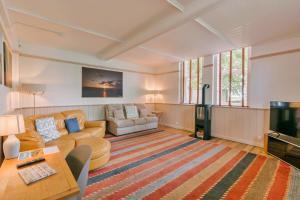 a living room with a couch and a tv at Finest Retreats - Wallingbrook Lodge in Chulmleigh