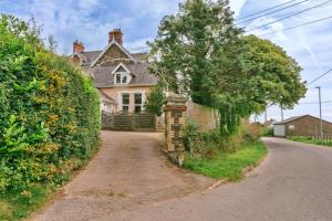 a house with a tree on the side of a road at Finest Retreats - Wallingbrook Lodge in Chulmleigh