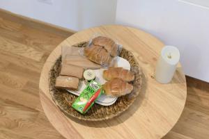 a basket of bread and pastries on a table at Fenêtre sur le Neron in Quaix