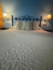 a large white bed with two pillows on it at APARTAMENTOS La Colmena APT- 2 - AT-CC-00248 in Gata