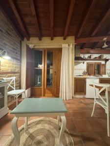 a kitchen with a table in the middle of a room at APARTAMENTOS La Colmena APT- 2 - AT-CC-00248 in Gata