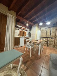 a kitchen and dining room with a table and chairs at APARTAMENTOS La Colmena APT- 2 - AT-CC-00248 in Gata +15 photos