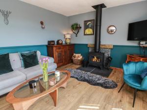 a living room with a couch and a fireplace at Crown Cottage in Dunfermline