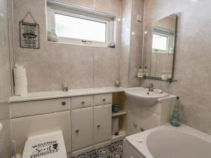 a bathroom with a sink and a toilet and a mirror at Crown Cottage in Dunfermline +37 photos